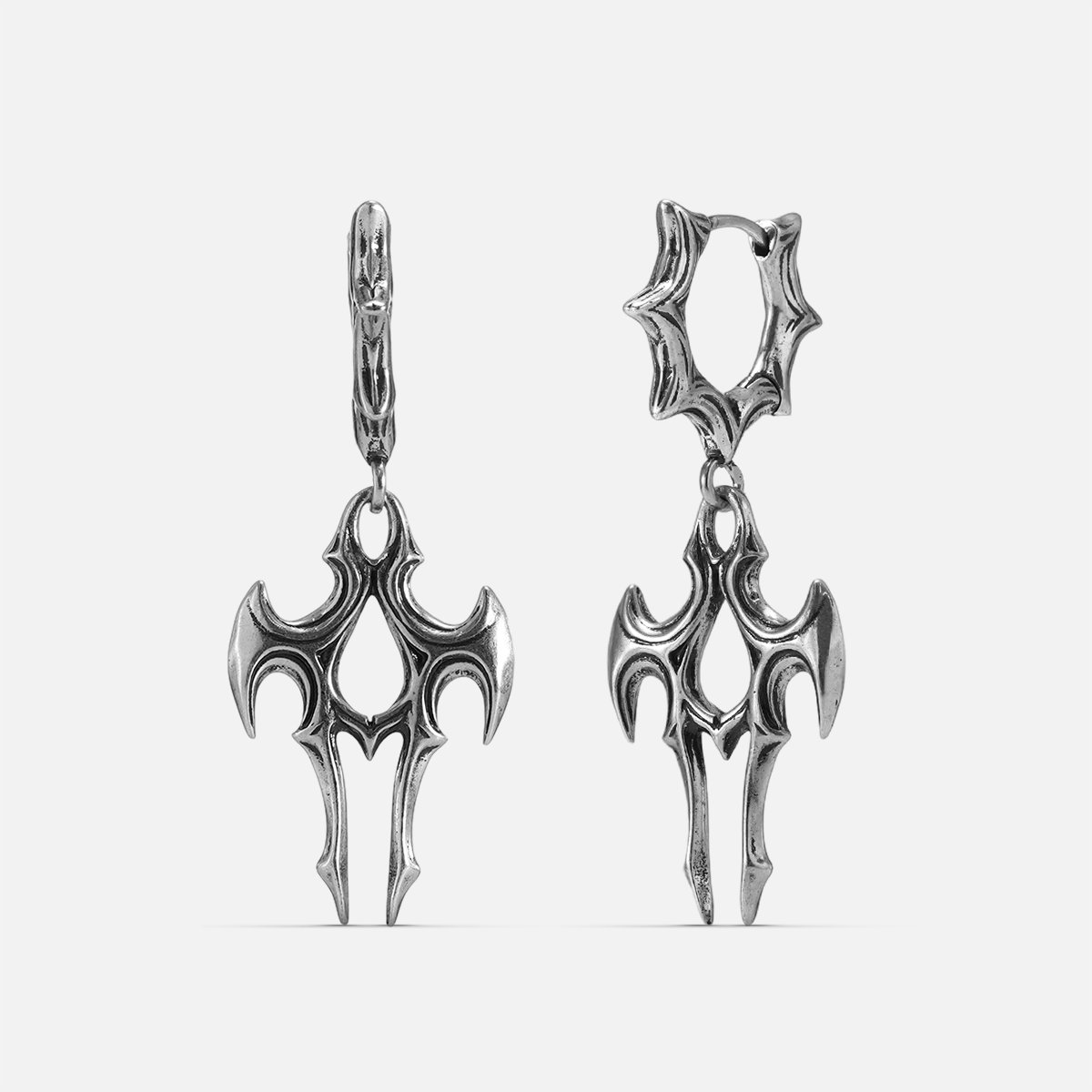 Pair of silver-tone talon shaped drop earrings with spiked hoop closures, shown against a plain background