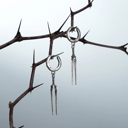Longinus Twin Spear Earrings in 925 sterling silver, pair hanging from thorn branches to emphasize the long twin-spear silhou