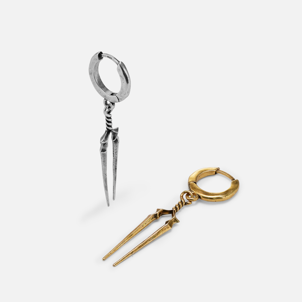 Silver and gold-tone Longinus Twin Spear hoop earrings arranged upright and flat