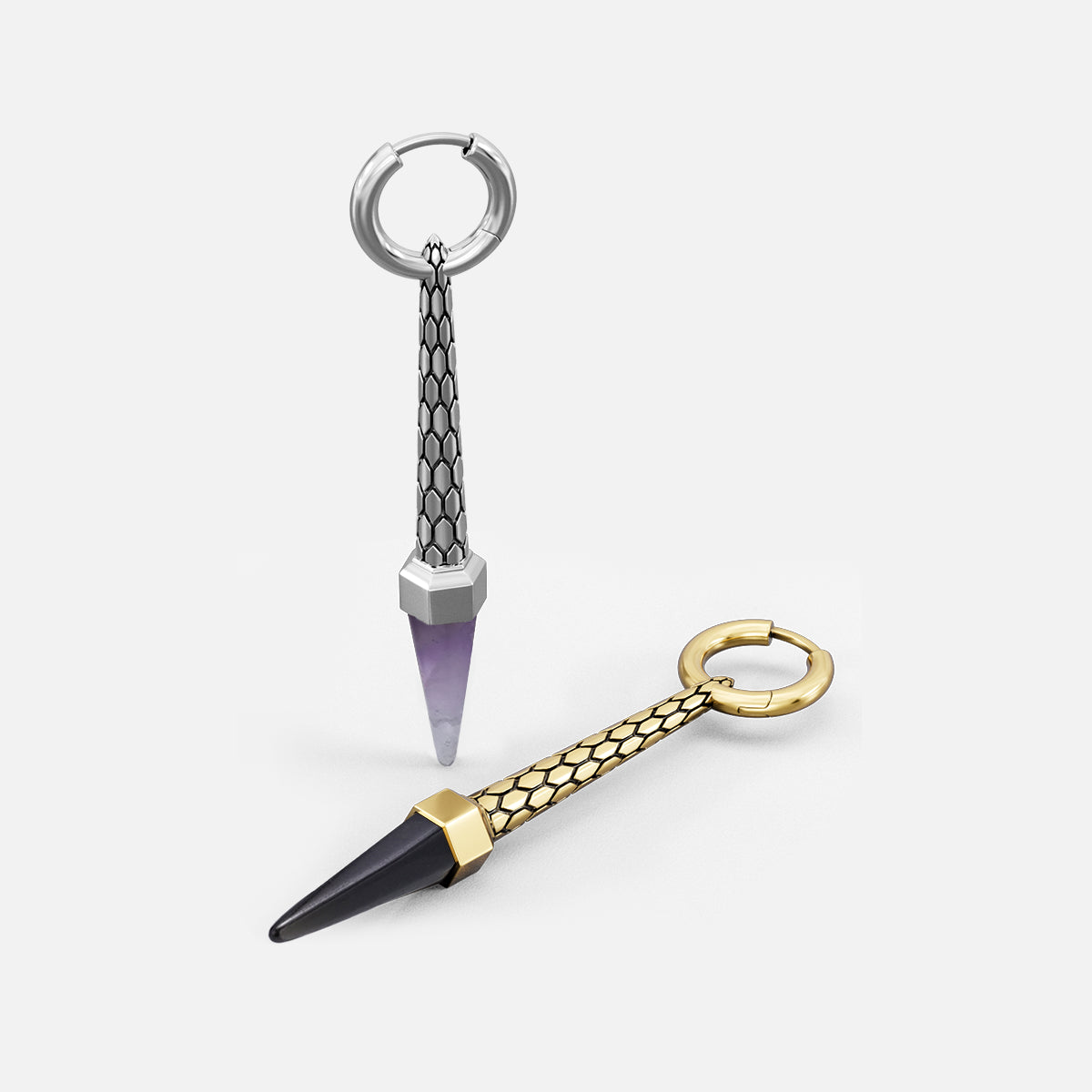 Two hoop earrings shown at an angle, one silver-tone with purple crystal point, one gold-tone with dark point