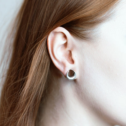 Close-up of silver Lunar Eclipse tunnel worn in a stretched lobe