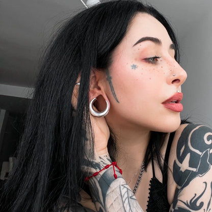 Model wearing a silver Lunar Eclipse tunnel in a stretched lobe