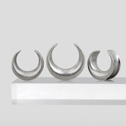 Three sizes of silver Lunar Eclipse tunnels displayed on a white pedestal