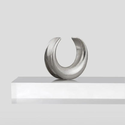 Single silver Lunar Eclipse tunnel displayed upright on a white pedestal