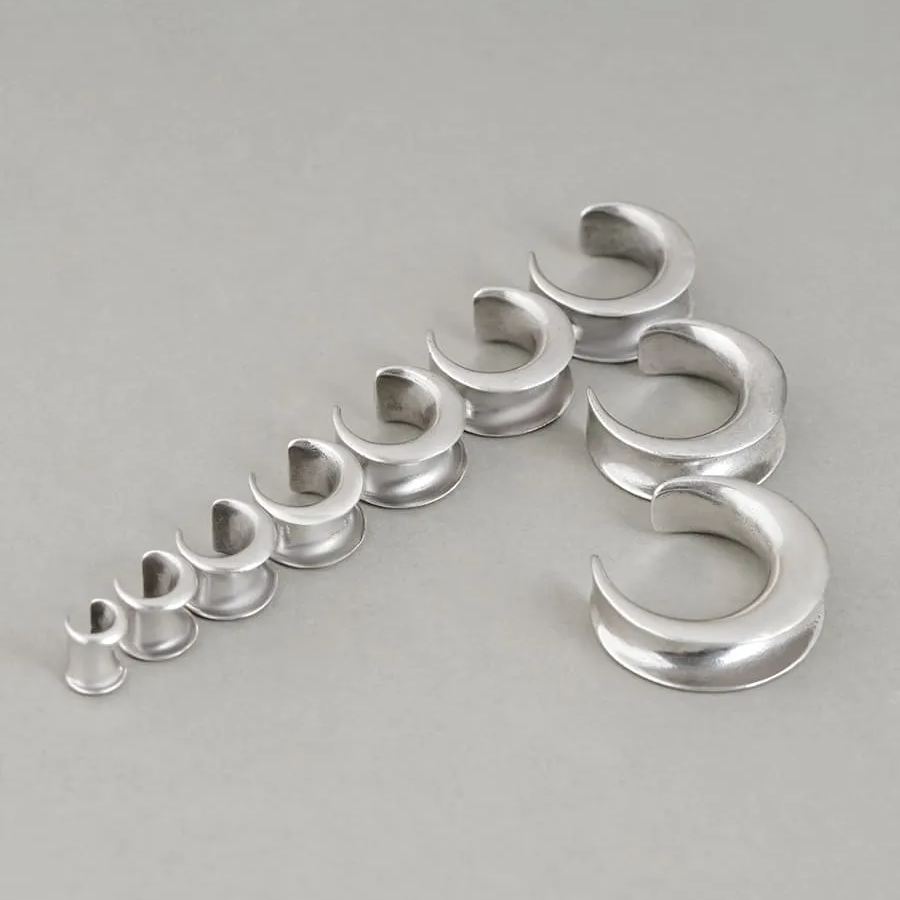 Silver Lunar Eclipse tunnels in graduated sizes arranged on a white surface