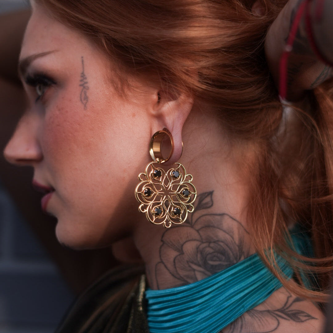 Gold-tone Mandala Bloom earring worn on a model, showing the circular floral filigree from the side