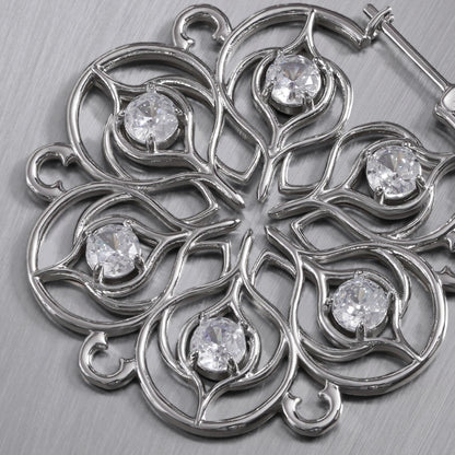 Close-up of silver Mandala Bloom earring with clear center accents