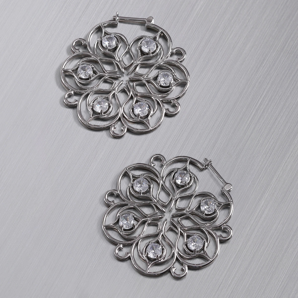 Pair of silver Mandala Bloom hoop earrings with clear center accents