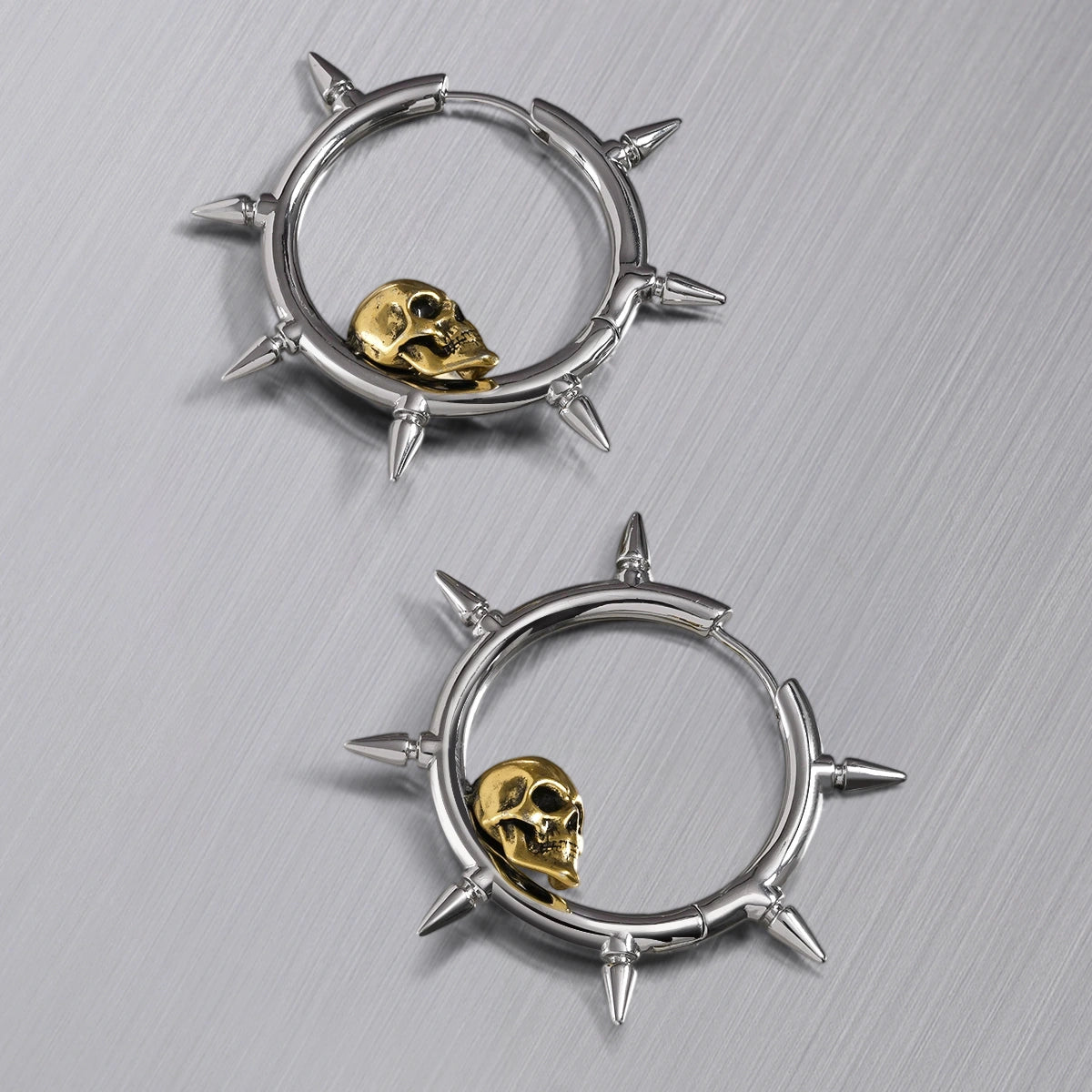 Pair of silver Memento Skull hoop earrings with spikes and gold skulls