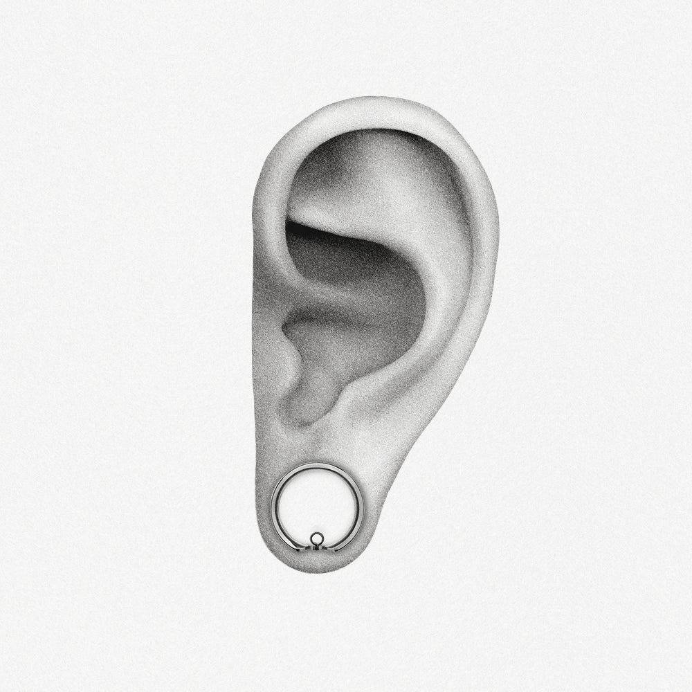 Silver-tone modular ring tunnel positioned in an illustrated earlobe to show the worn fit
