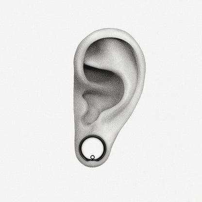 Black modular ring tunnel positioned in an illustrated earlobe to show the worn fit