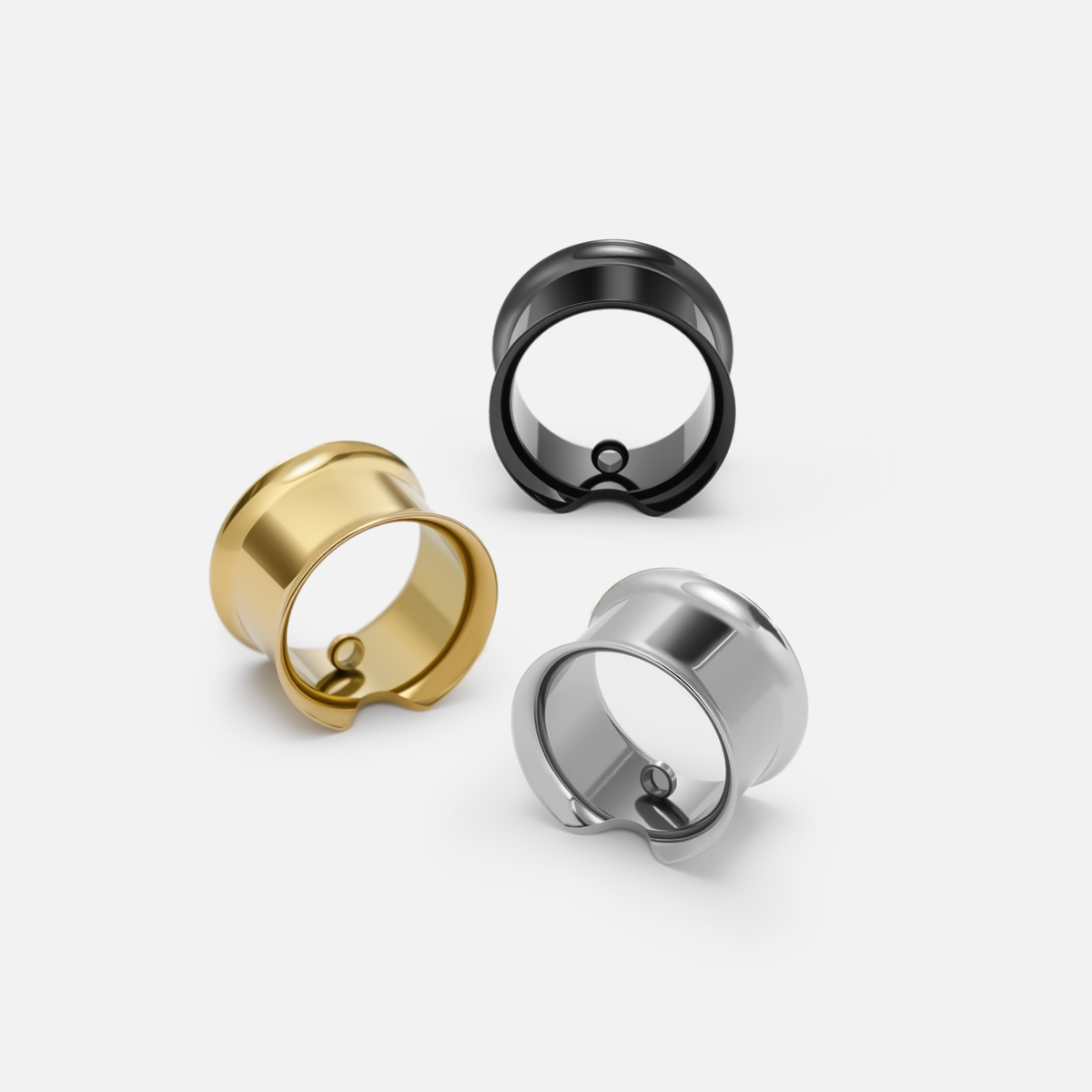 Gold, black, and silver modular ring tunnels arranged together in angled front and side views