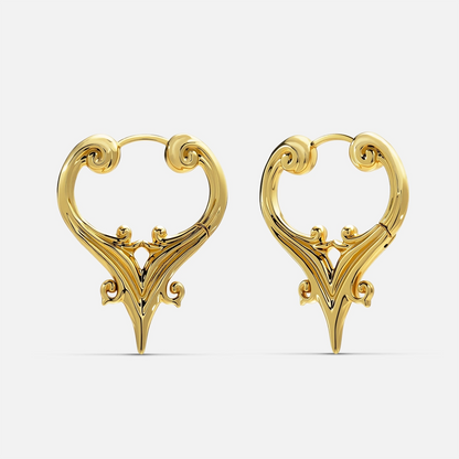 Gold-tone hoop earrings with a scrolled crest design and a pointed drop, shown as a pair against a plain backdrop
