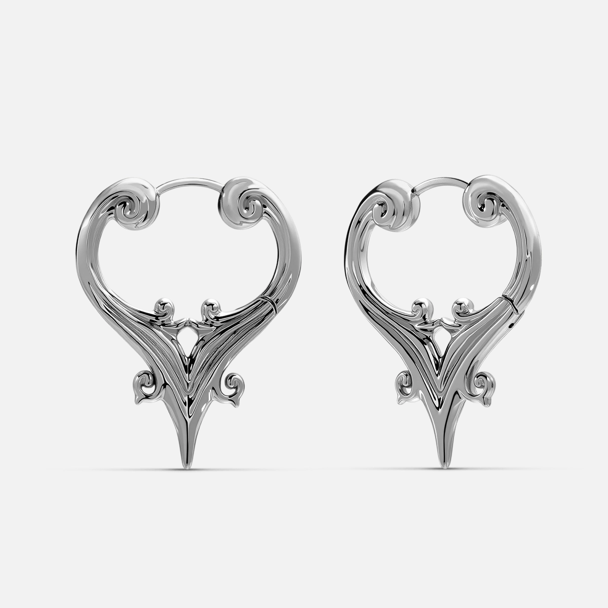 Pair of silver Mystic Crest heart hoop earrings with pointed lower details