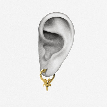 Gold Mystic Crest heart hoop earring shown on an ear illustration