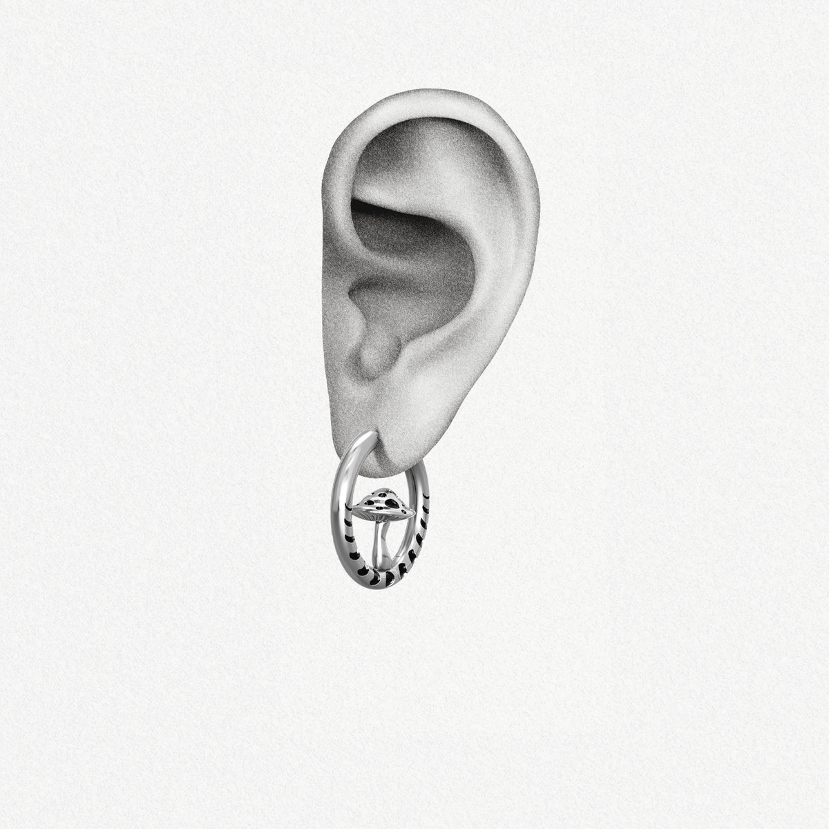 Silver Mystic Fungi hoop earring shown on an ear illustration