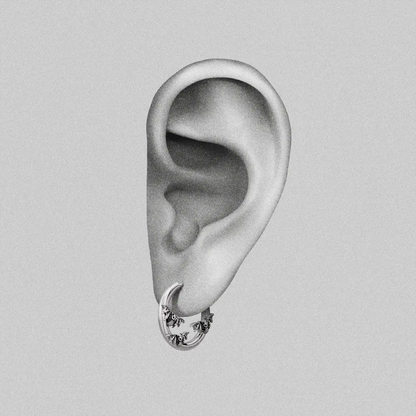 Silver Mystic Insight hoop earring with small bat details shown on an ear illustration
