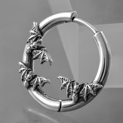 Close-up of silver Mystic Insight hoop earring with sculpted bat details