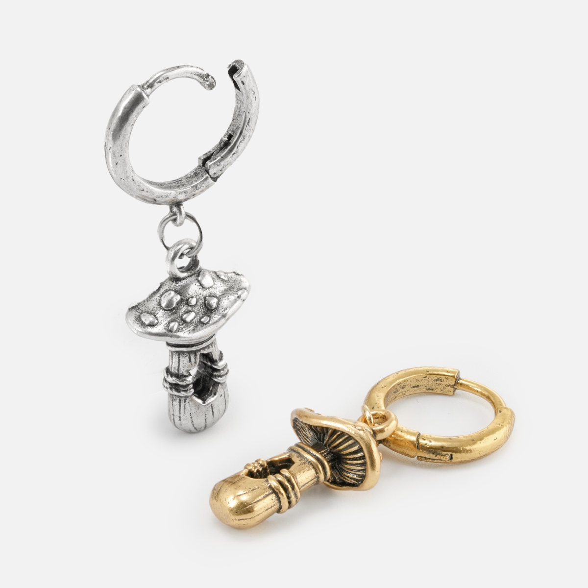 Silver and gold Mystical Mushroom hoop earrings shown open and lying flat
