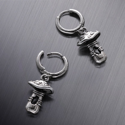 Three silver Mystical Mushroom hoop earrings shown from different angles