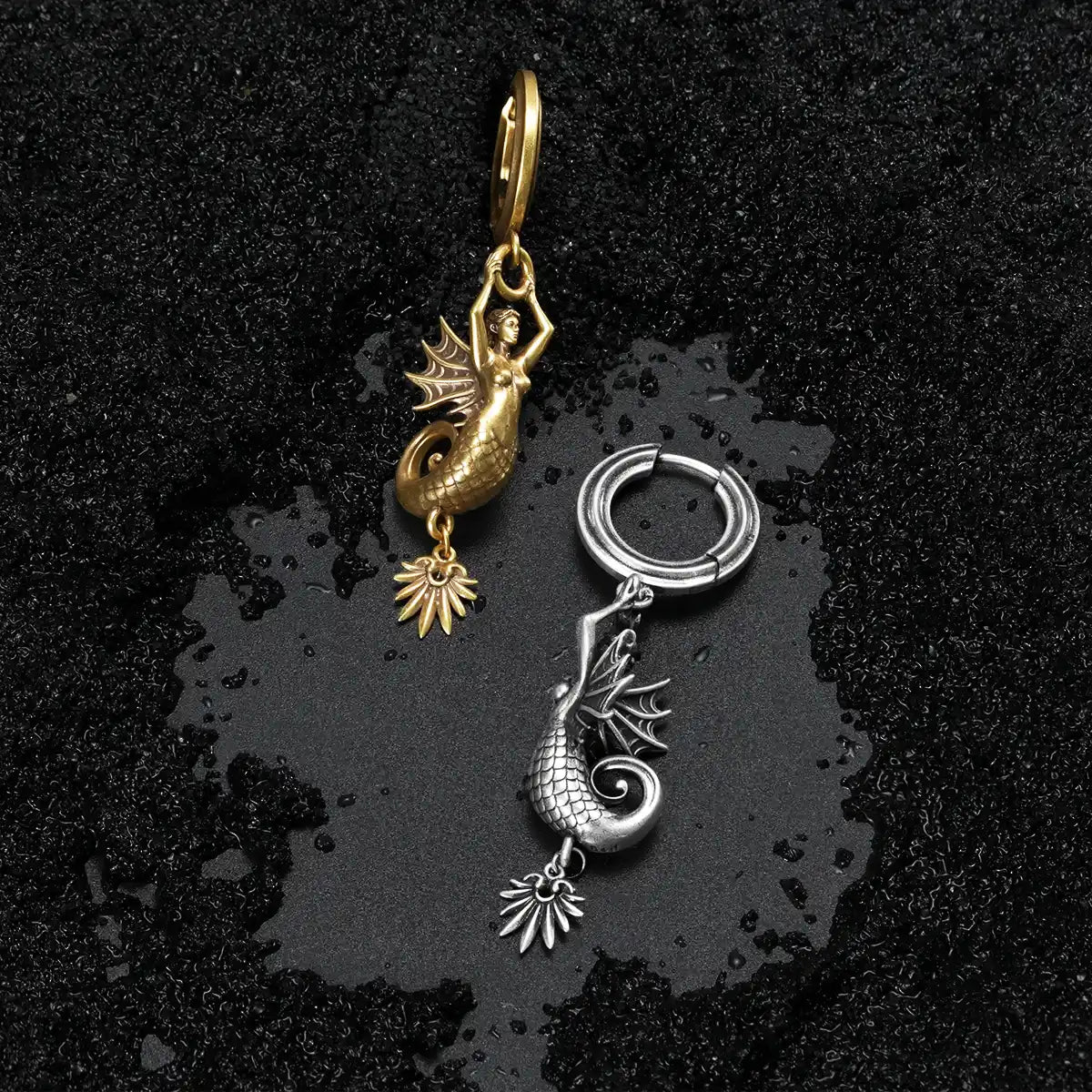 Ocean inspired mythic sea earrings in gold and silver finishes on a dark aesthetic surface
