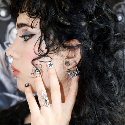 Ornate Affection Earrings in 925 sterling silver, styled on a curly-haired model with facial stickers, stacked silver earring