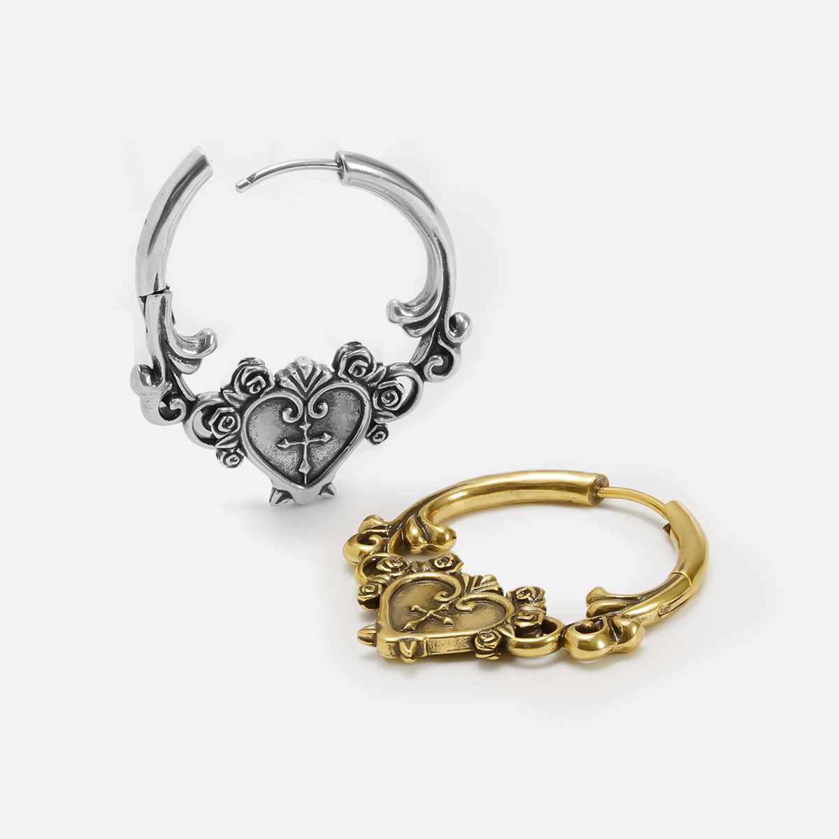 Silver-tone and gold-tone ornate hoop earrings with heart and cross detailing shown side by side
