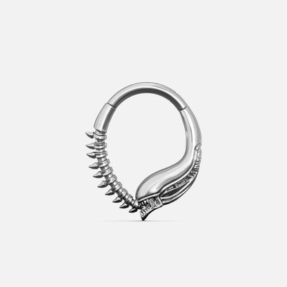 Silver-tone Ouroboros Clicker with a serpent-inspired curved form and raised spine details along the lower edge.