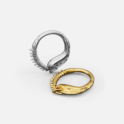 Silver- and gold-tone Ouroboros Clickers shown from multiple angles to display the curved profile and textured details.