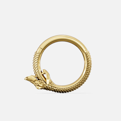 Gold-tone hoop clicker shaped like a snake biting its tail, textured scale detail, front view