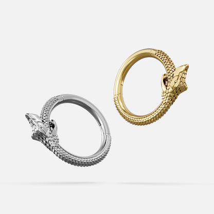 Silver and gold Ouroboros Coil clicker rings shown from side angles
