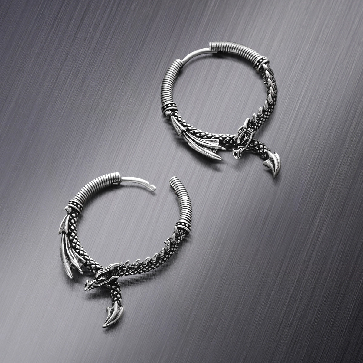 Pair of silver Ouroboros Dragon hoop earrings with wing and tail details