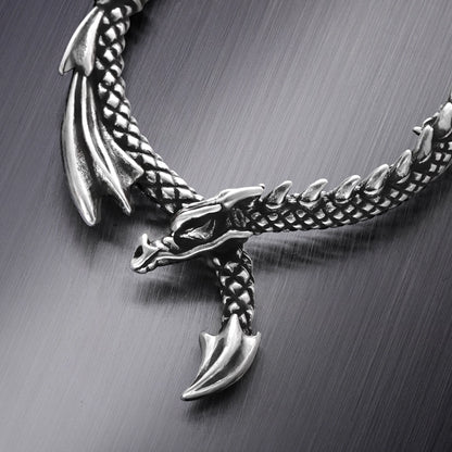Close-up of silver Ouroboros Dragon hoop earring with sculpted dragon details