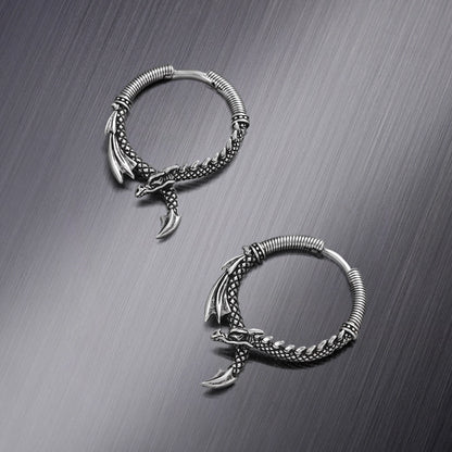 Two silver Ouroboros Dragon hoop earrings shown from different angles