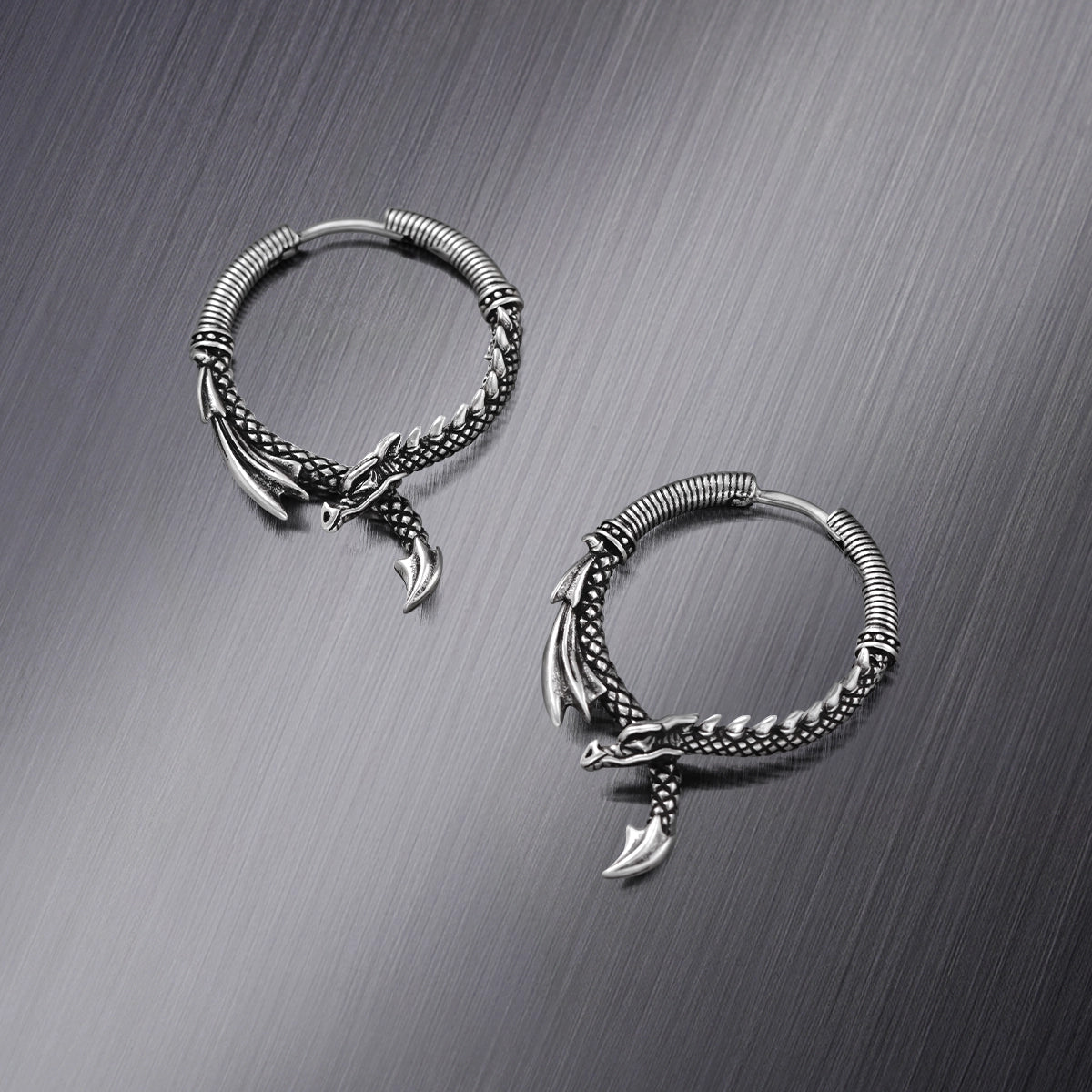 Pair of silver Ouroboros Dragon hoop earrings shown open and closed