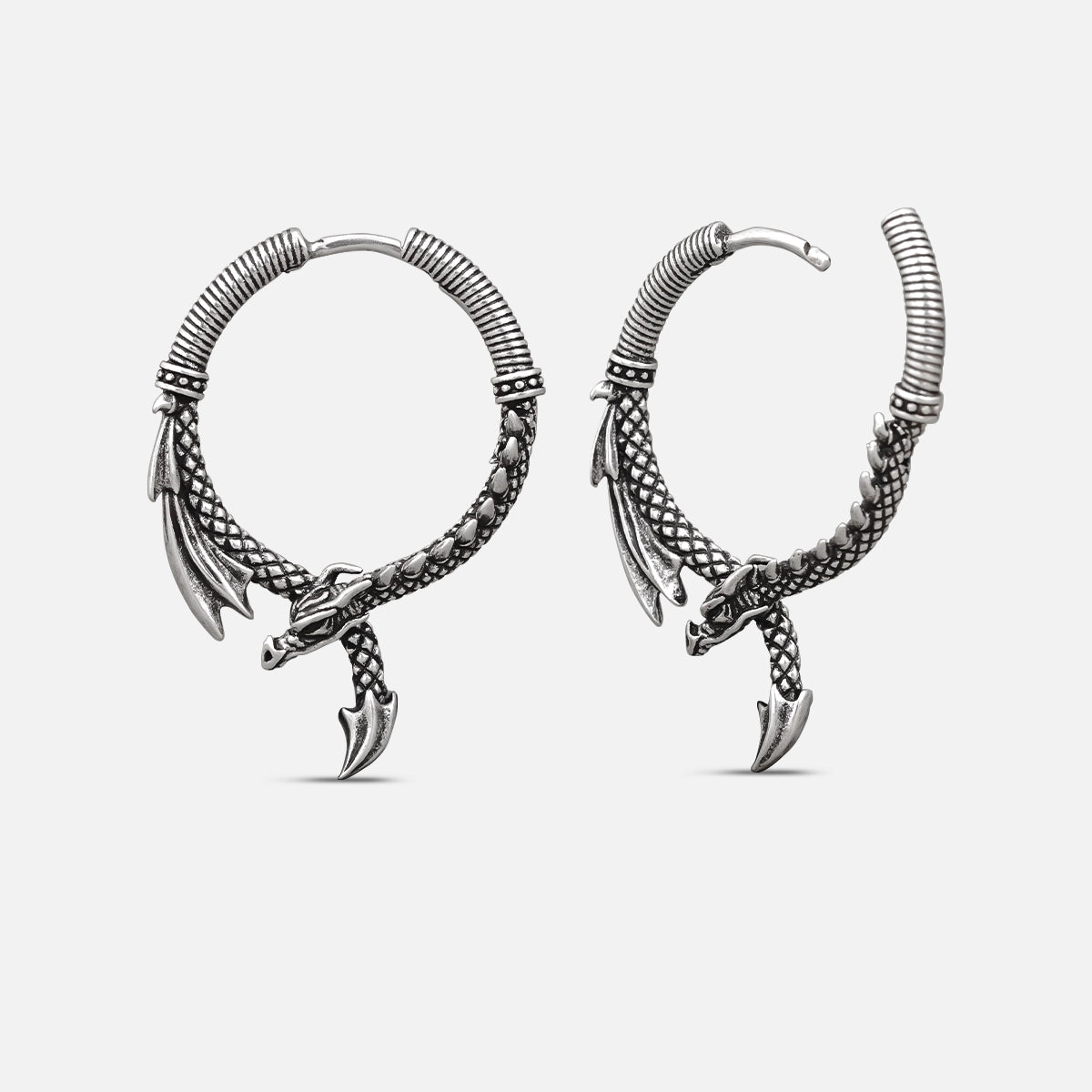 Pair of silver-tone dragon hoop earrings shown from front and side view against a light background
