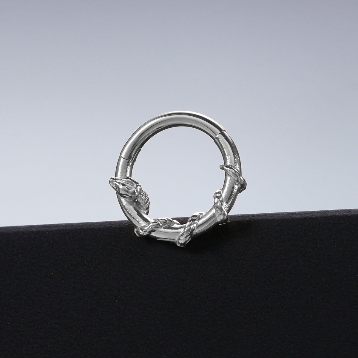 Silver Ouroboros Serpent clicker displayed against a black pedestal
