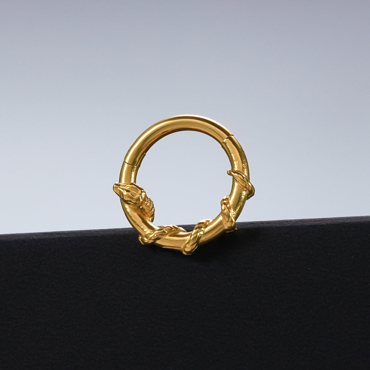 Gold Ouroboros Serpent clicker displayed against a black pedestal