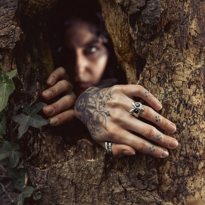 Model wearing Owl Sentinel Rings in dark forest setting with witchwood inspired styling