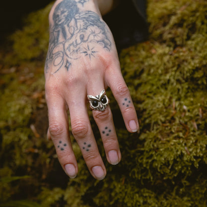 Owl Sentinel Rings worn on hand in forest setting with dark woodland jewelry styling