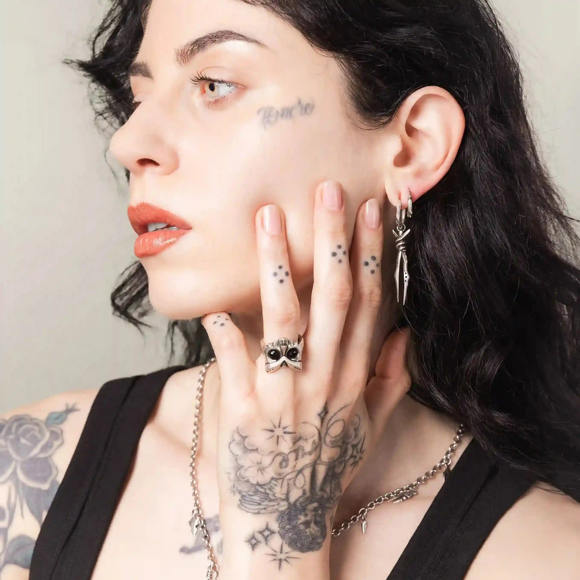 Model wearing Owl Sentinel Rings with silver owl skull detail and gothic jewelry styling