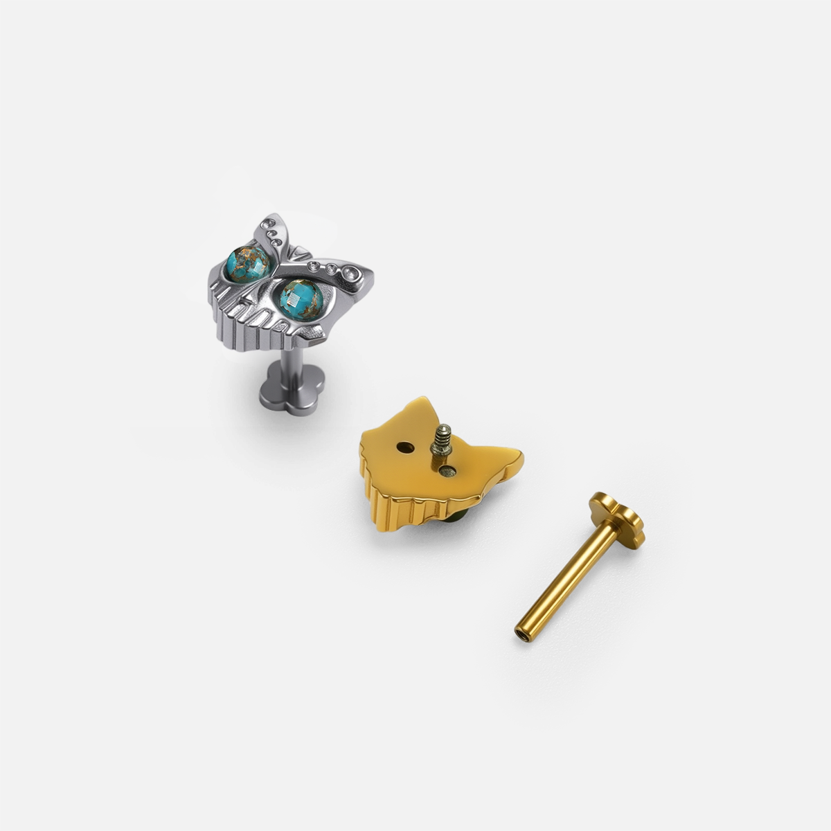 Owl Skull Ear Studs shown in polished titanium and 18K gold PVD with turquoise and obsidian options