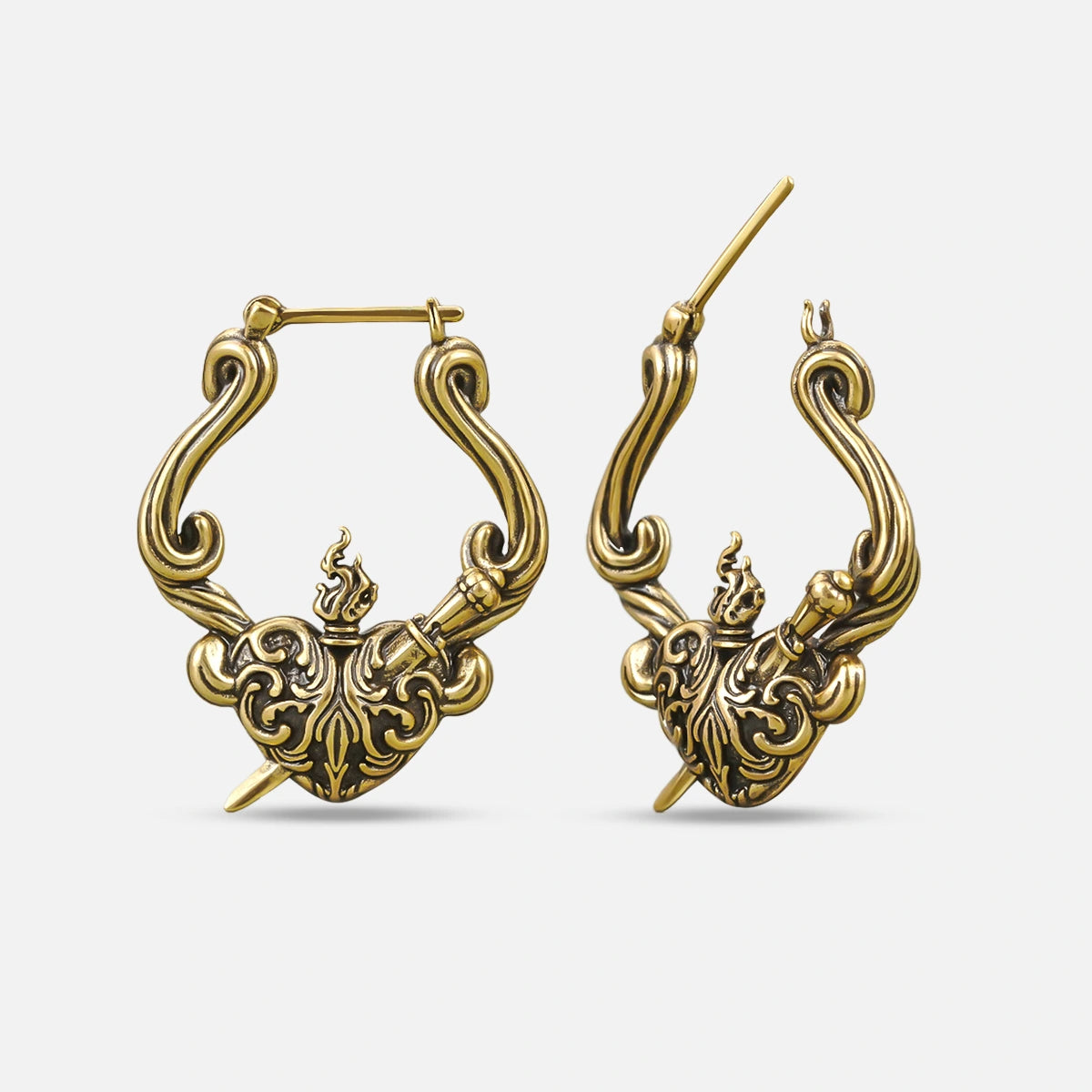 Pair of antique gold-tone hoop earrings with a flaming heart and dagger motif, shown front and side view