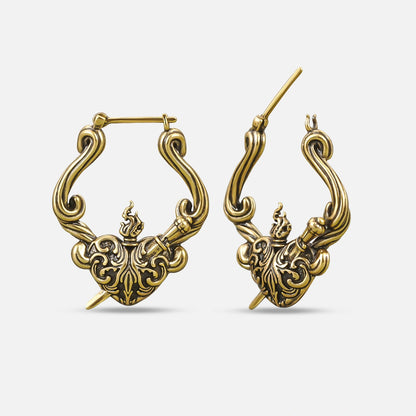 Pair of antique gold-tone hoop earrings with a flaming heart and dagger motif, shown front and side view