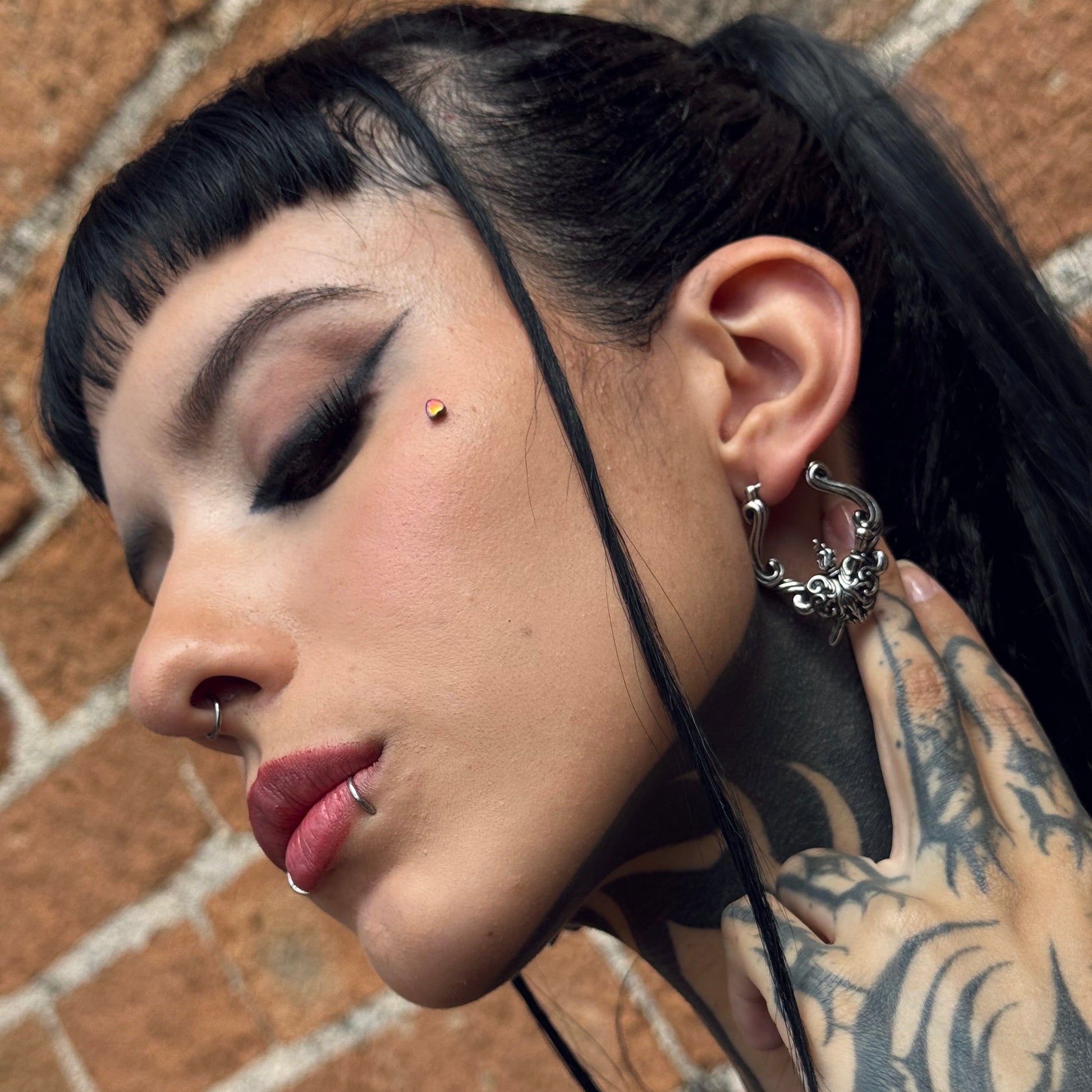 Model wearing a silver Passionate Heart hoop earring