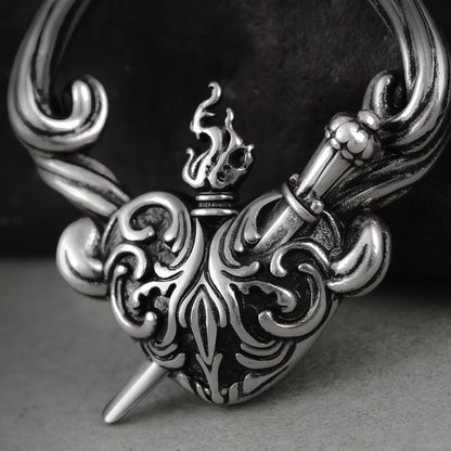 Close-up of silver Passionate Heart earring with flame and scroll details