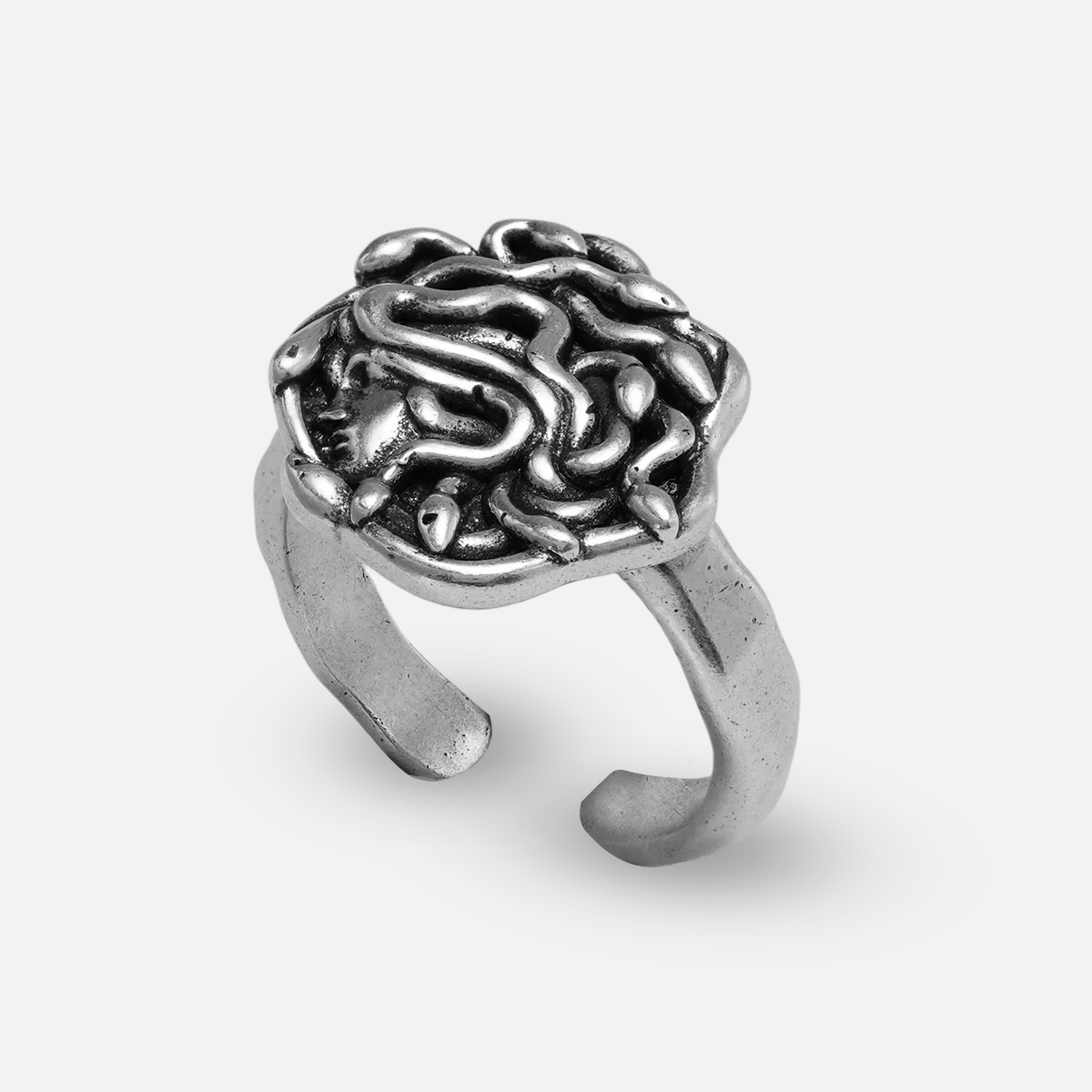 petrified gaze ring in silver shown in an angled view, featuring a medusa-inspired ring face with sculptural snake details