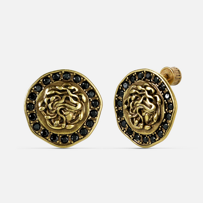 petrified nocturne ear studs in gold shown in a front view, featuring medusa-inspired stud earrings framed with obsidian details