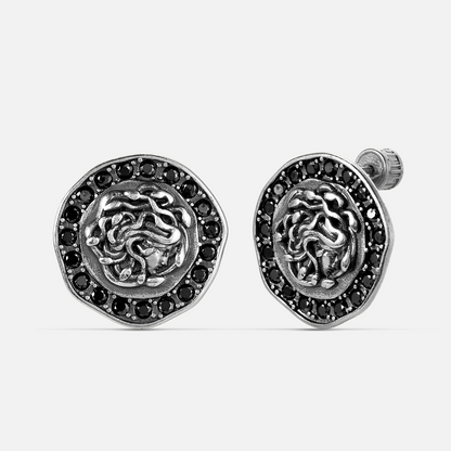petrified nocturne ear studs in silver shown in a front view, featuring medusa-inspired stud earrings framed with obsidian details
