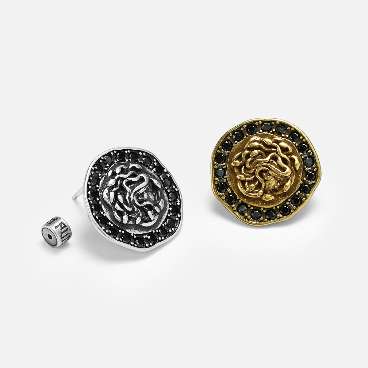 petrified nocturne ear studs shown in silver and gold in a product view, featuring medusa-inspired ear studs framed with obsidian stones